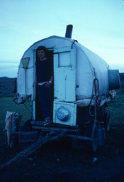 Sheepherder standing in camp wagon doorway
