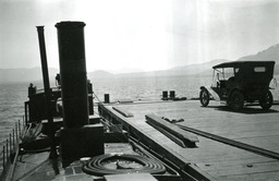 Steamer Tahoe on Lake Tahoe alongside pier with automobile on