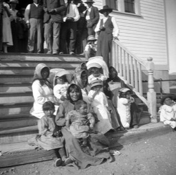 Paiute women and children sitting on steps