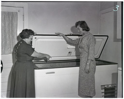 Two women with donated deep freezer, 2