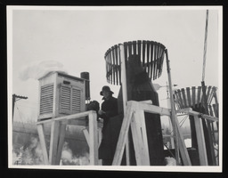 Worker with thermometer station and snow gauges