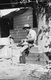 Man plucking a bird at Carl Dodge Ranch