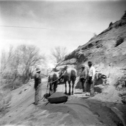 Workers with horses moving dirt
