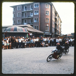 Crowd observing motorcycle racers