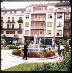 People walking in courtyard with fountain