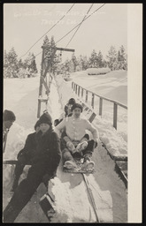 Children on toboggan pull-back lift