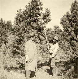 Col. Dorrington and Native American holding pine nut pole
