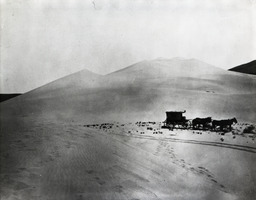 Timothy O'Sullivan's ambulance wagon and portable darkroom used during the King Survey rolls across the sand dunes of the Carson Desert, Nevada