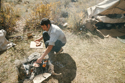 Herder preparing food over open fire