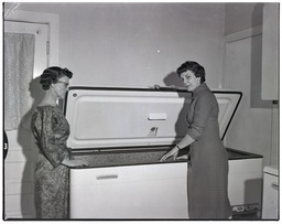 Two women with donated deep freezer, 1