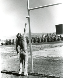 Painting the goal post, Mackay Stadium, 1979
