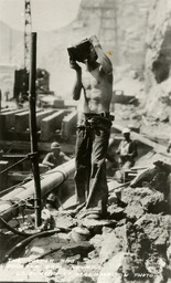 Man drinking water at Hoover Dam construction site
