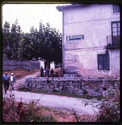 People standing by old building