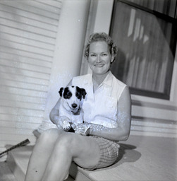 Bette Sawyer sitting on a porch with a dog