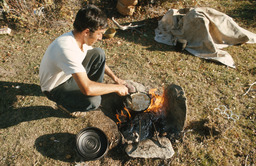 Herder cooking over open fire