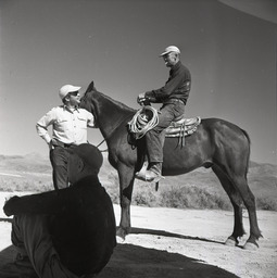 Man on horse, man standing, man sitting