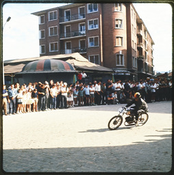 Crowd observing a motorcycle racer