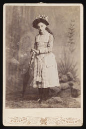 Unidentified young girl holding an umbrella
