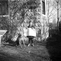 Young child with dog in front of St. Mary's Episcopal Church in Nixon, Nevada