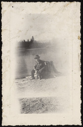 Man with dog on lake shore