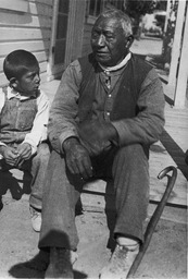 Man and boy sitting on porch
