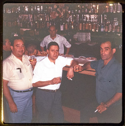 Men drinking and smoking at a bar