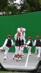 Oinkari male dancers holding man aloft