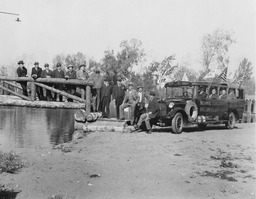 Men posing on a bridge next to a bus, Reno, Nevada, circa 1925