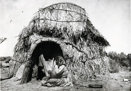 Paiute woman and house
