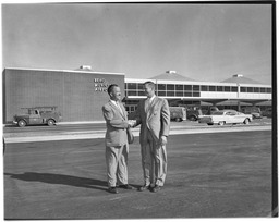 Two men shake hands outside the Reno Municipal Airport