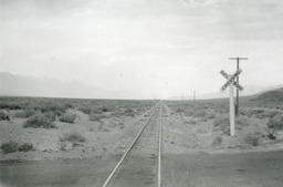 The tracks of the Southern Pacific narrow gauge at a road crossing between Lone Pine and Owenyo (1950)