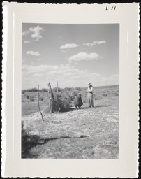 Two men next to wire fence, copy 1