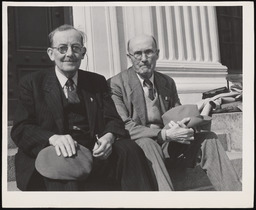 Dr. Church sitting with man on steps