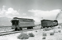 Southern Pacific Combine No. 401 sits as a freight train switches a box car (1950)
