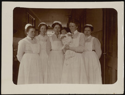 Alfred Marcel Jacobson with nurses, 12 days old