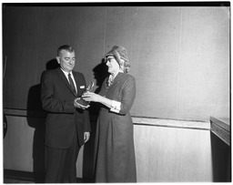 Nevada Federation of Women's Clubs luncheon, Dr. W. W. Hall accepts trophy from Mrs. Clarence K. Bath