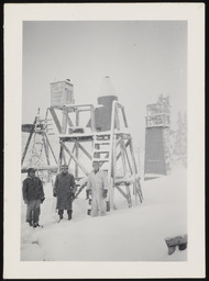 Dr. Church and colleagues standing in front of snow gauge