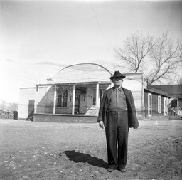 Man standing in front of house