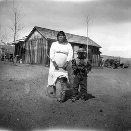 Woman with young boy and infant in cradleboard