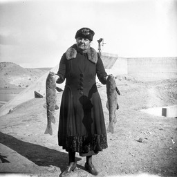 Woman holding two fish