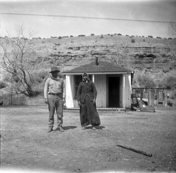Man and woman standing in front of house