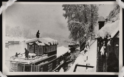 Removing snow from roof of houseboat