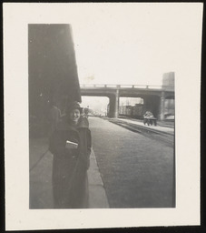 Barbara standing by bridge and railroad tracks