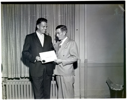 Bob Sullivan accepts a certificate of appreciation from John Koontz