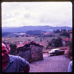 Shack in front of countryside, man in frame