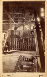 Millworkers posed with equipment in a mill