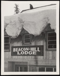 Man on Beacon-Hill Lodge roof with a snow cornice