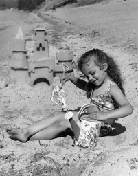 Girl playing on the beach, ca. 1958-1975