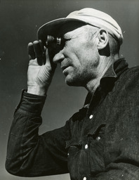 Man looking with binoculars, wild horse hunt