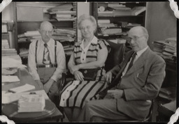 Dr. Church and two people sitting in office